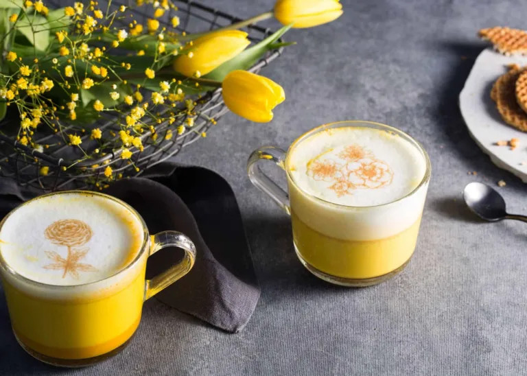 Turmeric latte topped with a Ripples Print of flowers 
